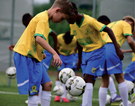 Young players in yellow Sundowns shirts practising their ball skills