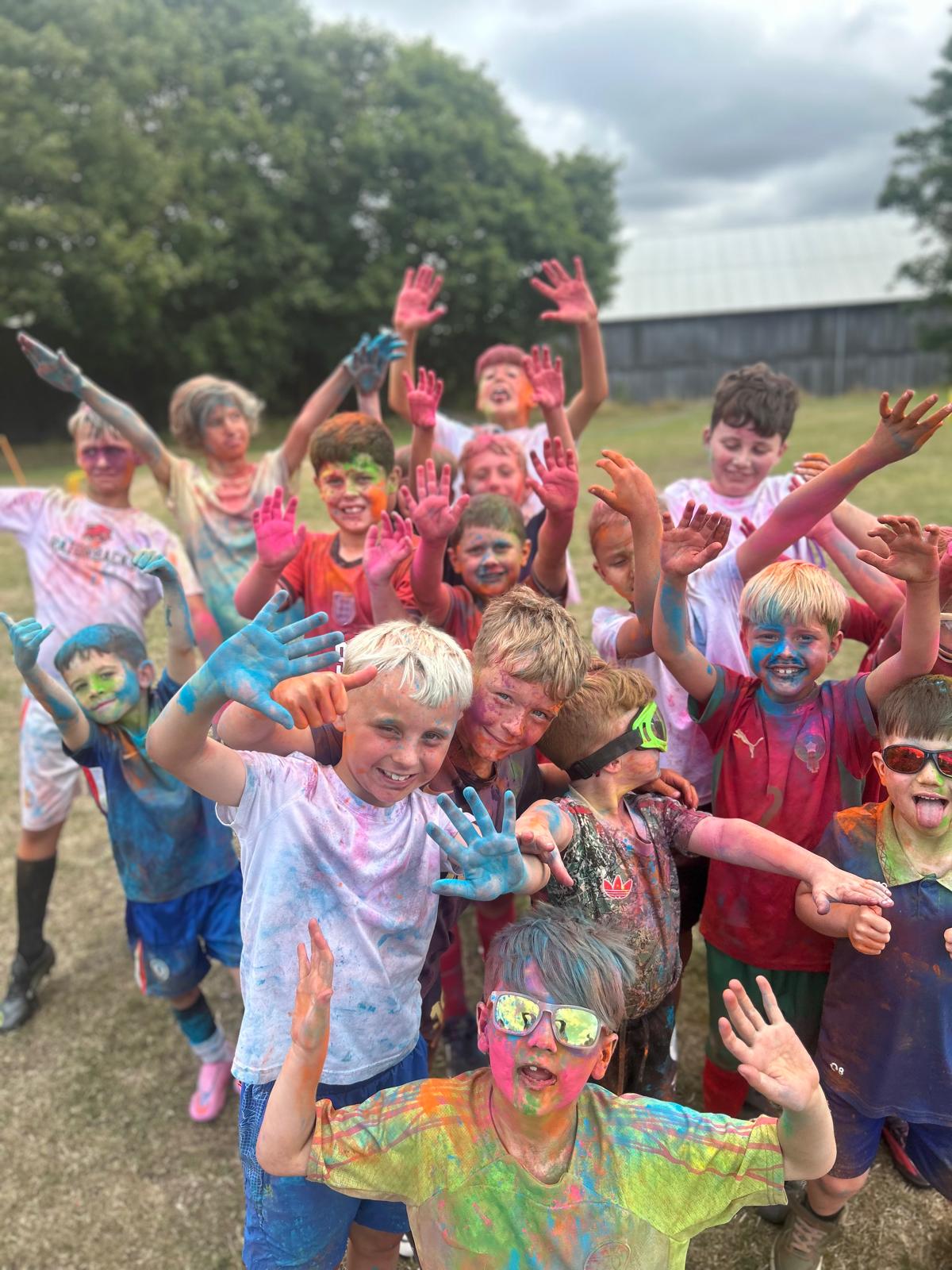 Children enjoying a colourful outdoor holiday club activity
