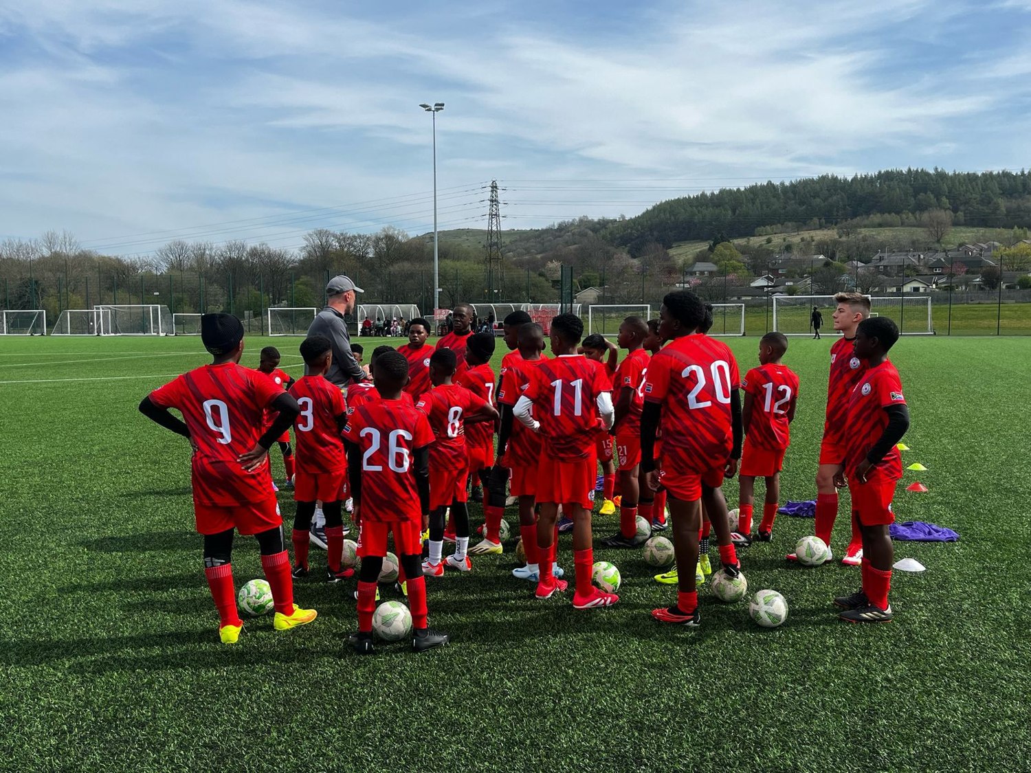 Young football team gathered on the pitch